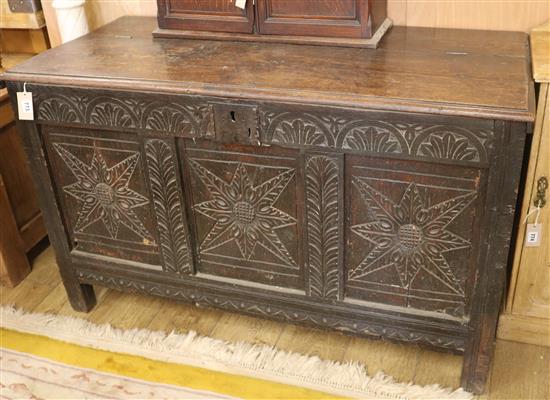 A carved oak coffer W.125cm